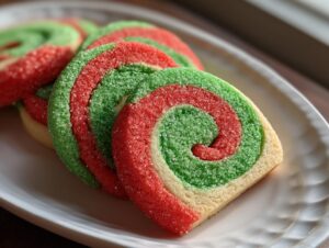 Close-up of festive red, green, and white pinwheel cookies rolled in sparkling sugar.
